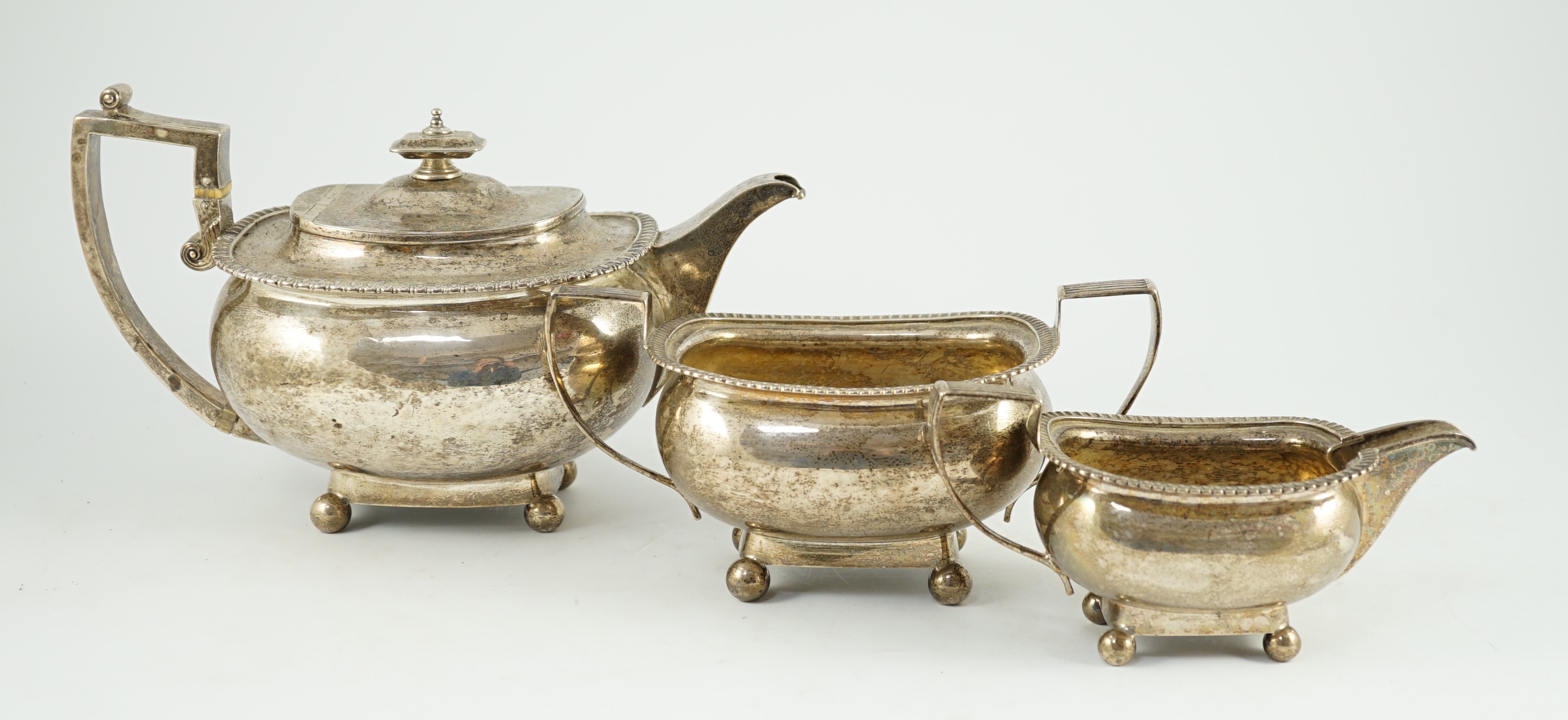 A George III silver three piece 'London' shape tea service, by Samuel Hennell